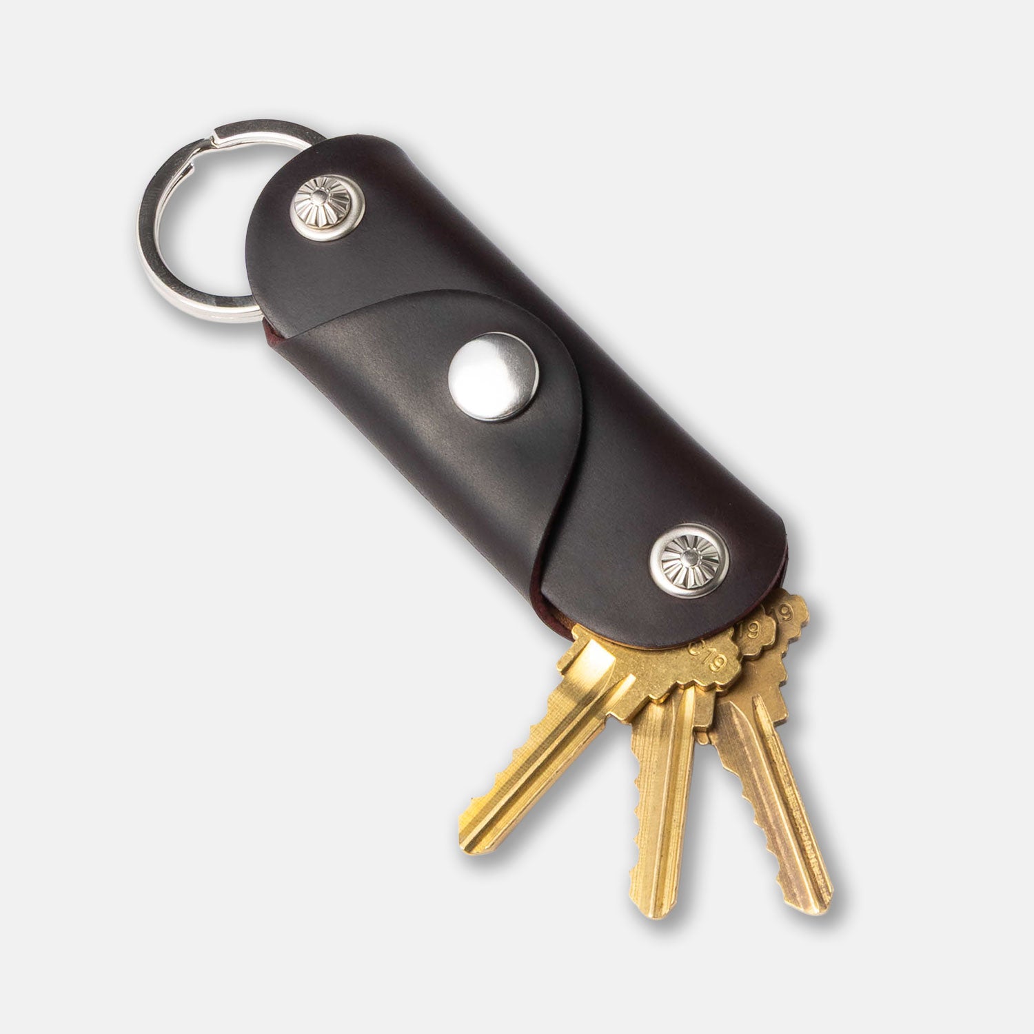 brown leather key fob with keys on white background