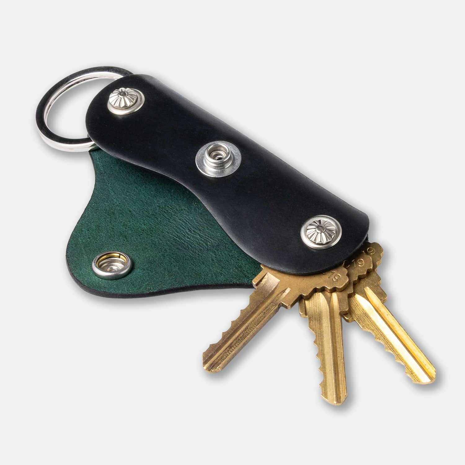 Keychain with green leather pouch and gold keys on a white background