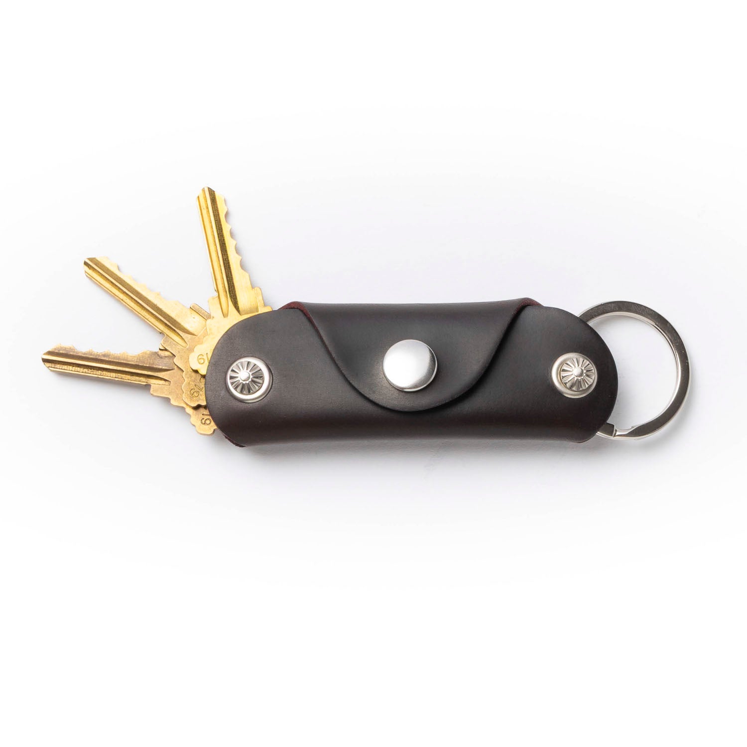 Brown key organizer with keys on a white background