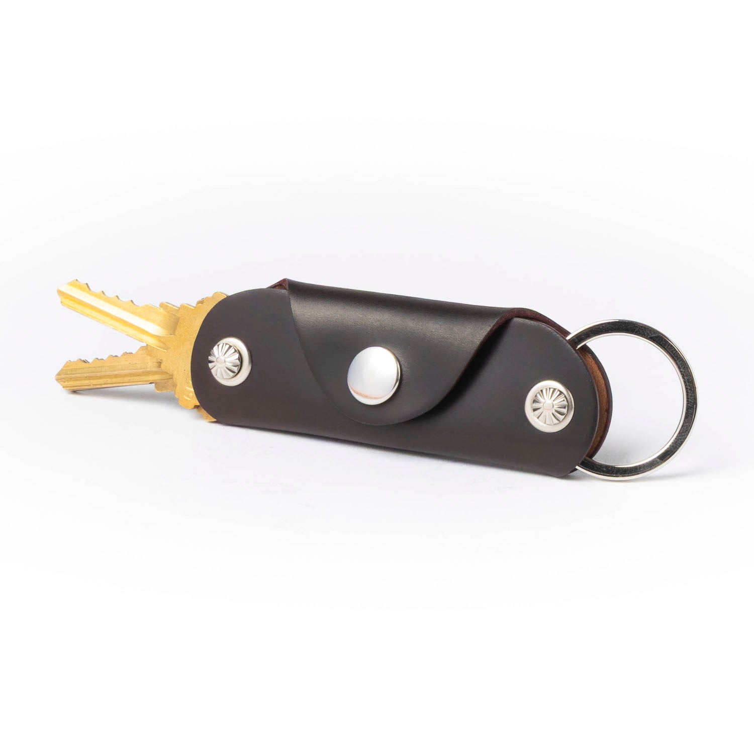 Keychain with keys and a brown case on a white background