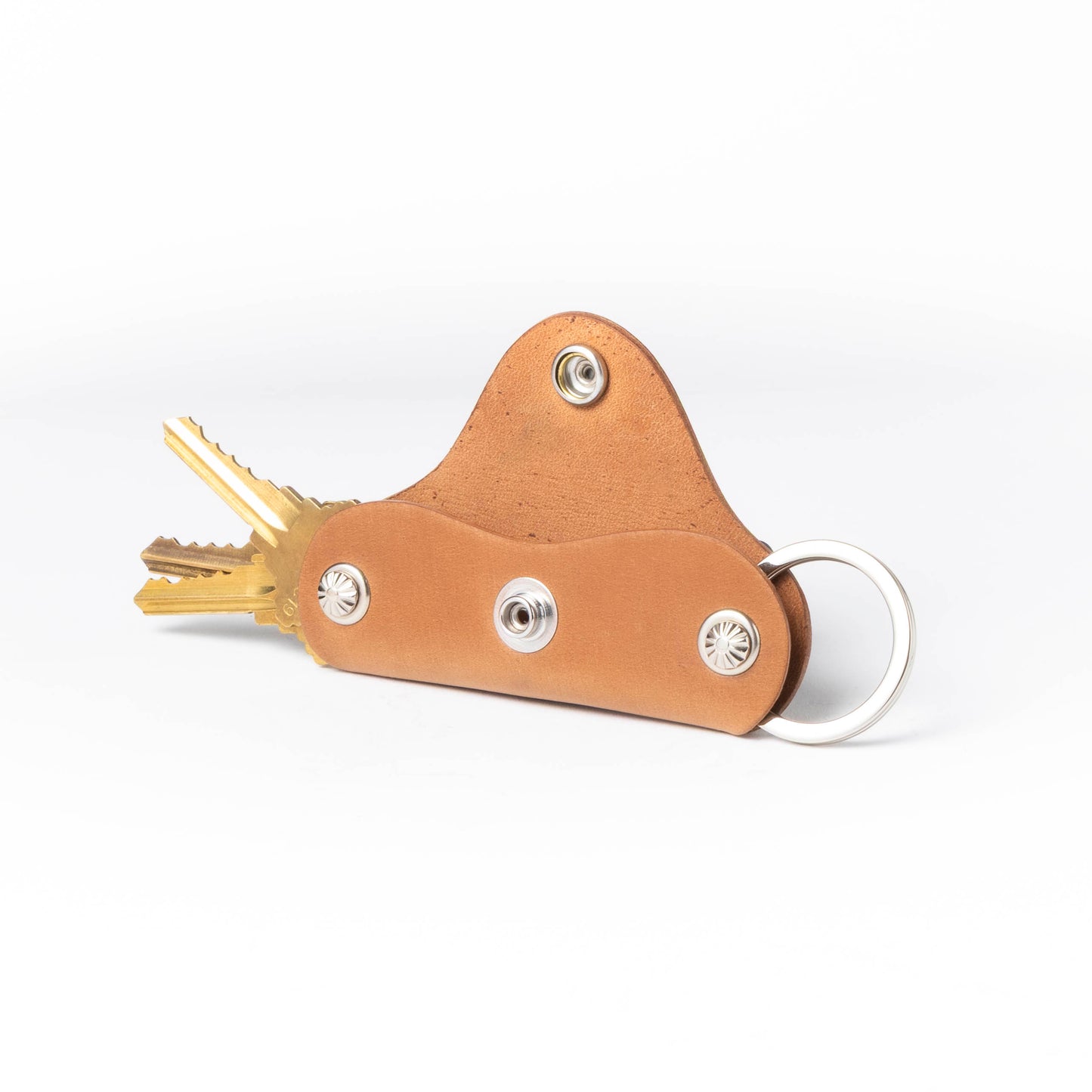 Brown leather key organizer with keys on a white background