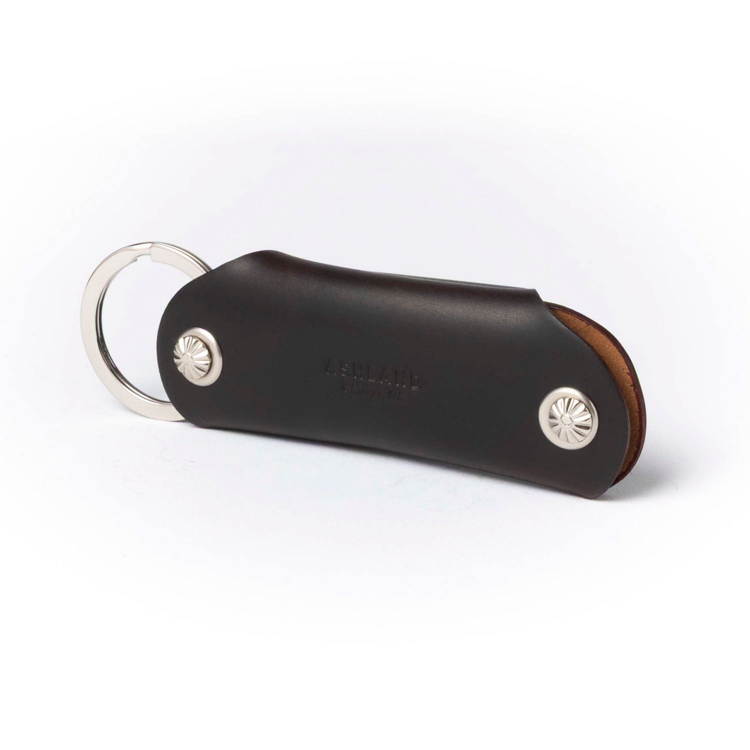 Brown leather keychain with metal ring on a white background