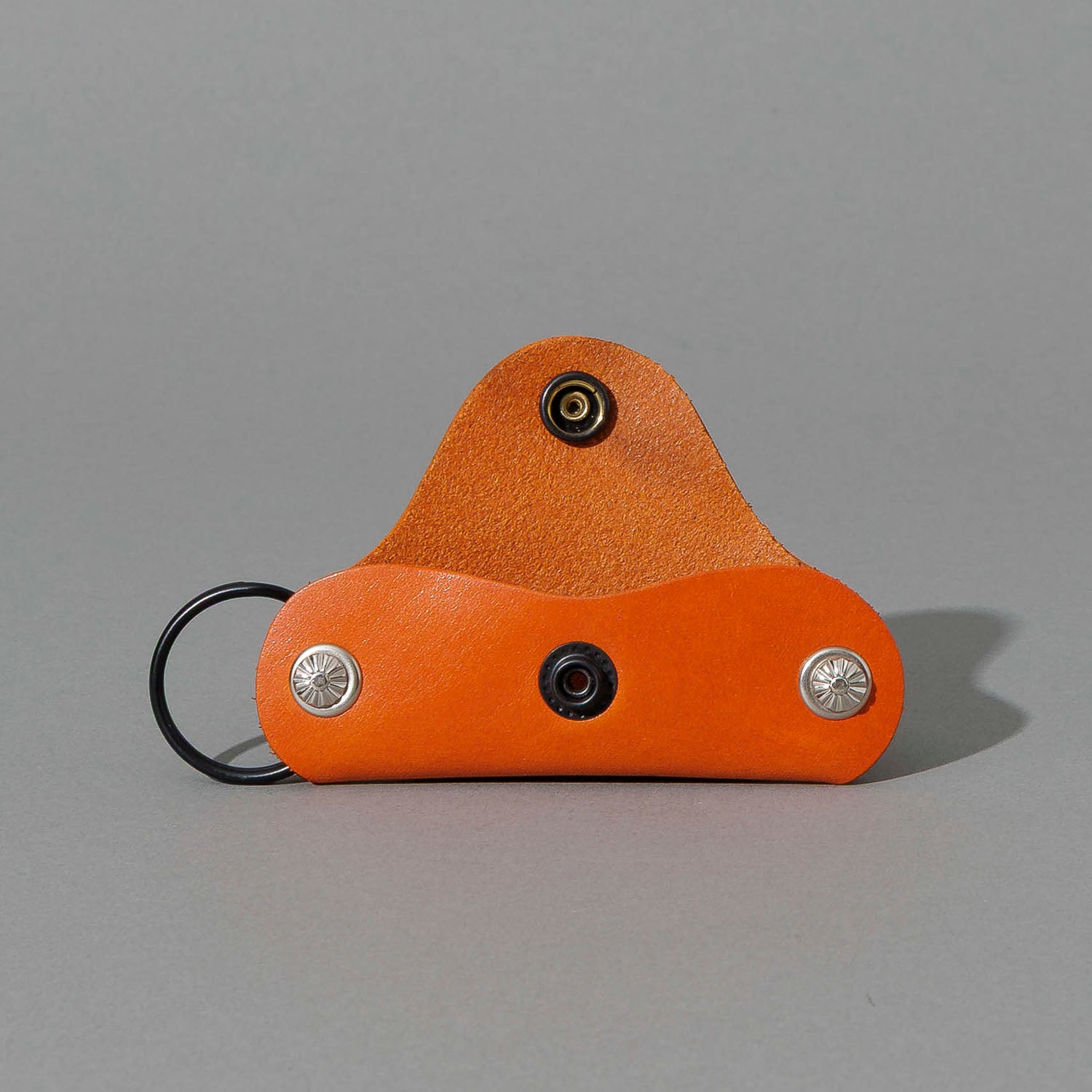 Vault Key Holder in Orange Latigo, opened to show where keys sit, shot 1