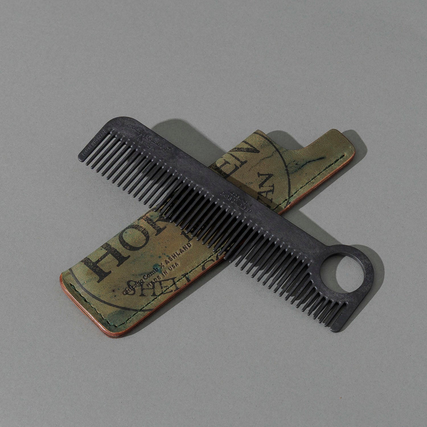 Chicago Comb and Leather Sheath in Reverse Shell Cordovan, with a black Chicago Comb crossed over the sheath