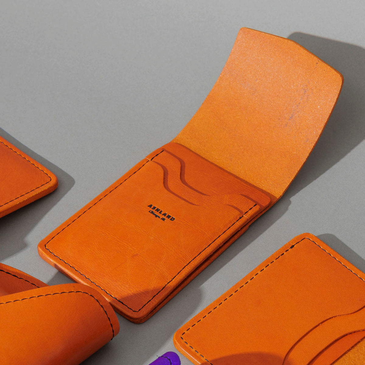 One-Off Lucky Wallet in Epic Orange Latigo, group shot with other Fall Limited Release pieces