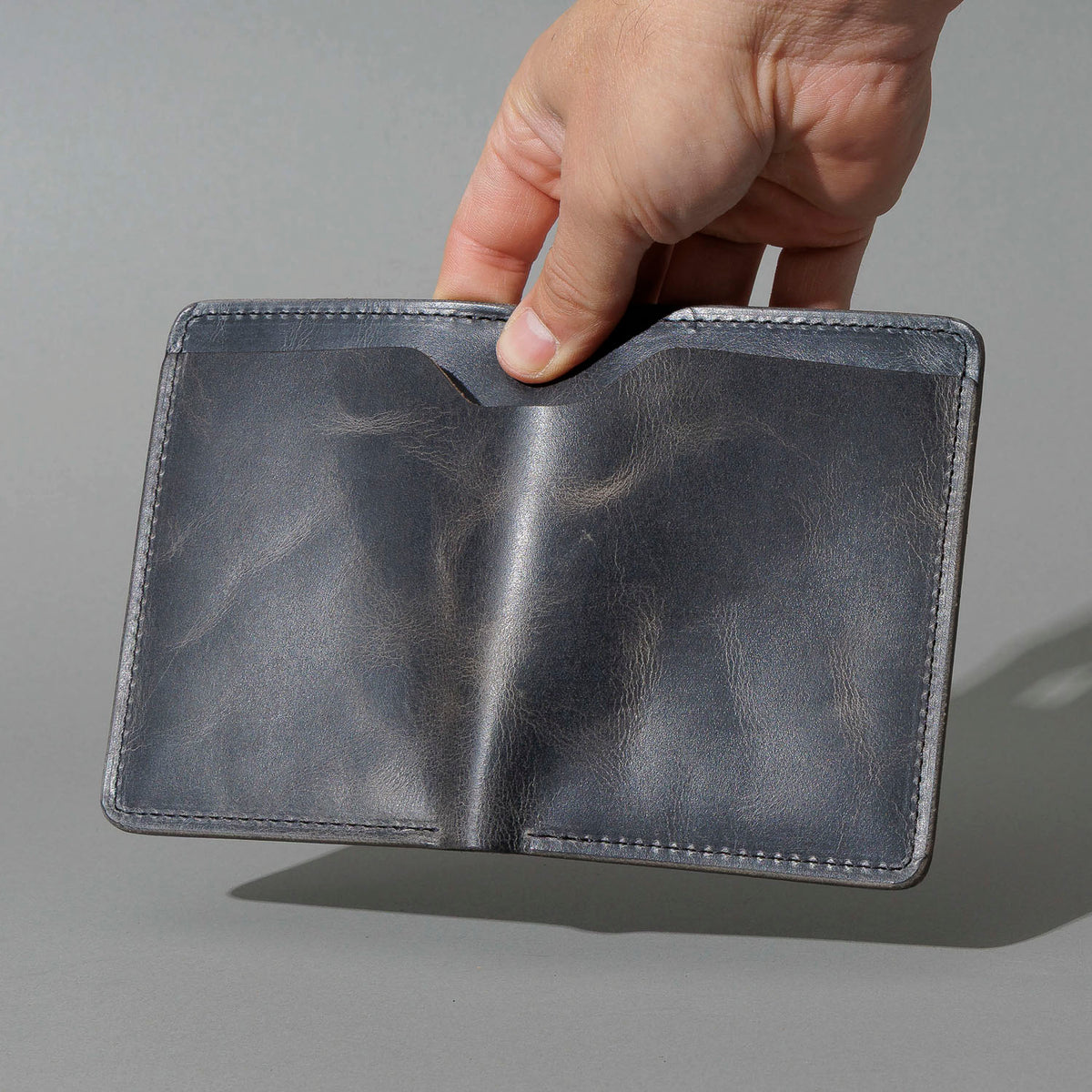 One-Off Fat Herbie in Slate Vintage, Horween® USA Stamp, held open in hand, shot 2