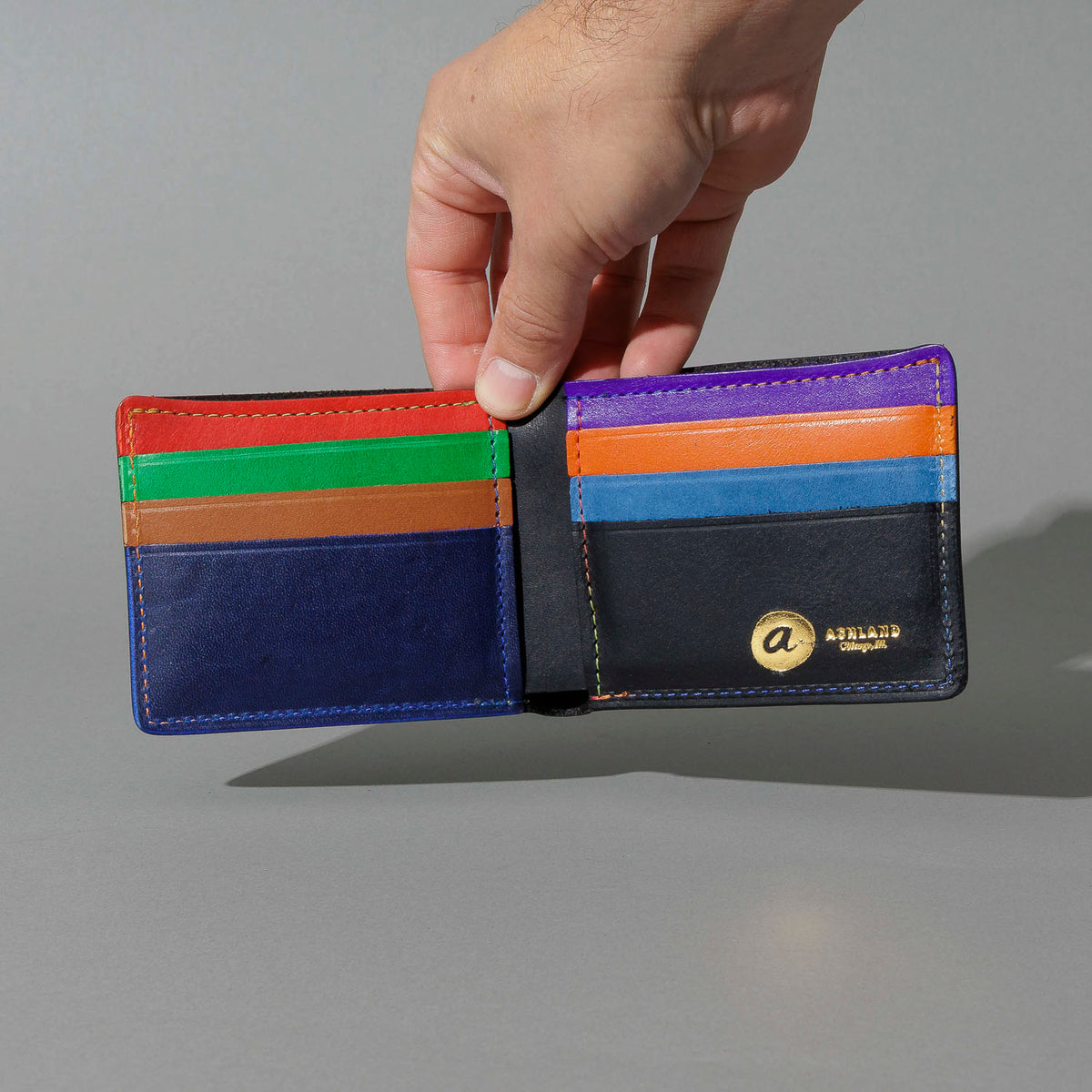 Johnny the Fox in Black Dublin with Multicolor Interior, held open in hand, shot 2