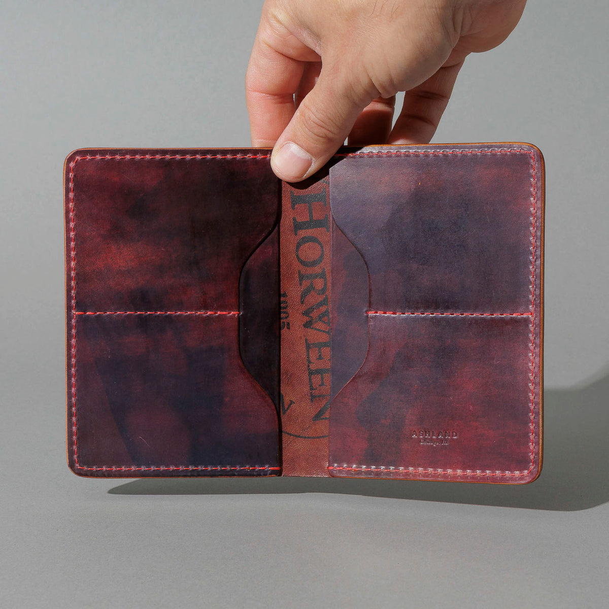 One-Off Traveler Passport Holder in Psychedelic Color 8 Shell Cordovan, No Bill Slot, held open in hand, shot 2