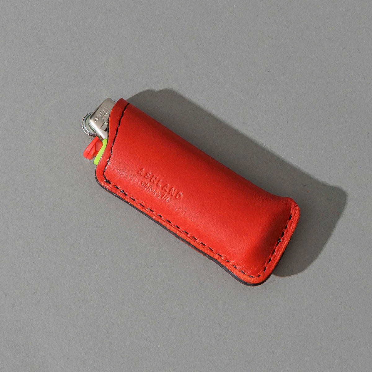 One-Off Skeleton Lighter in Red Latigo, angled view lying flat