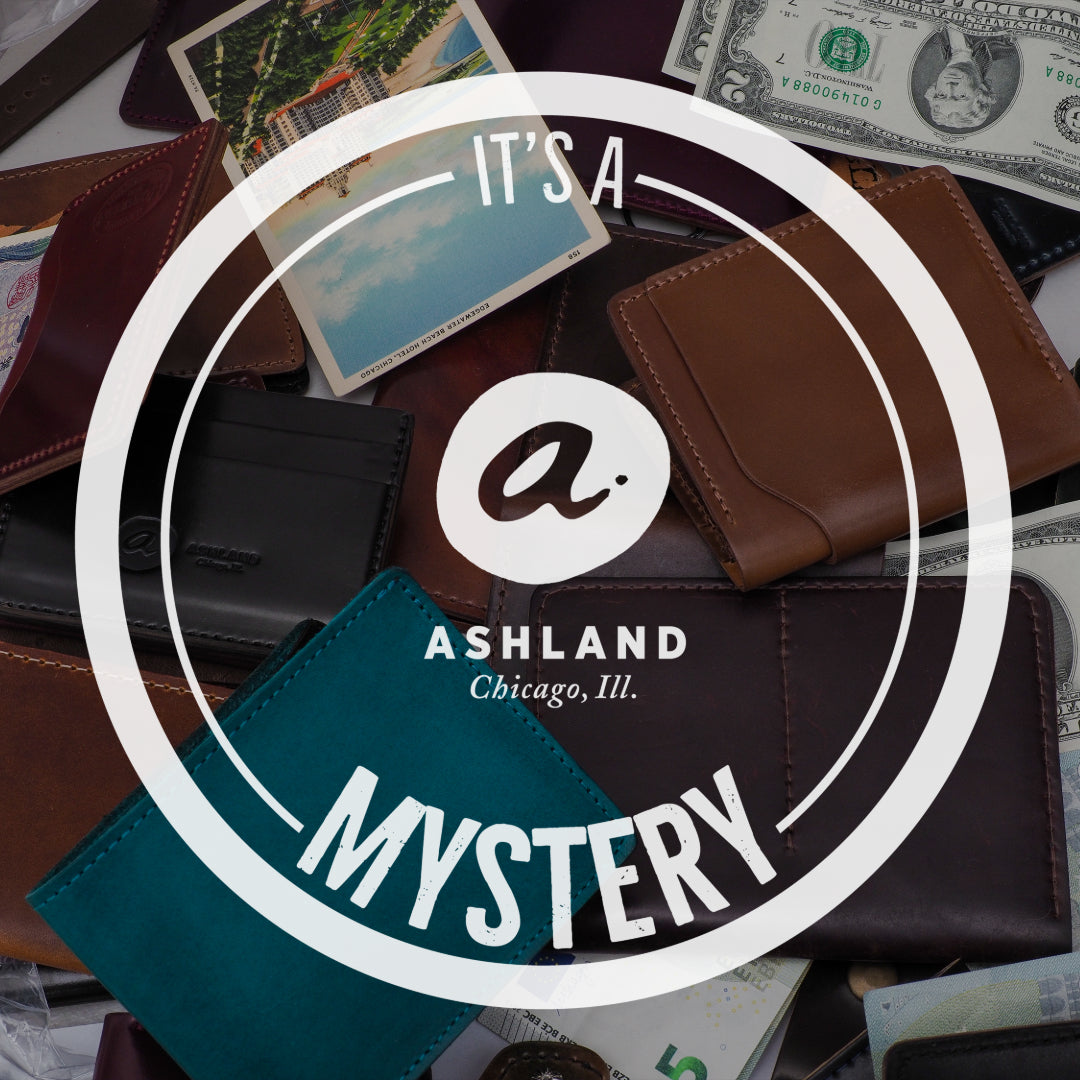 Ashland Leather Mystery Box, It's a Mystery logo over Horween® leather wallets and accessories