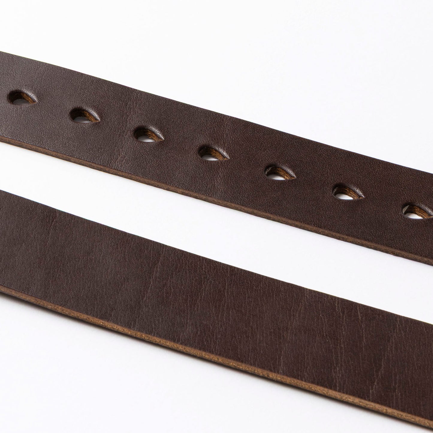 Two brown leather straps with holes on a white background