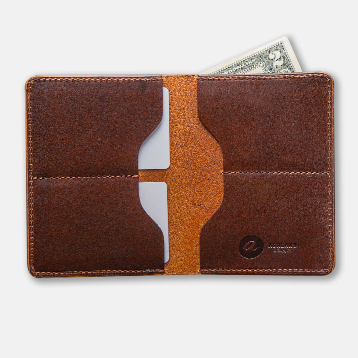 Fat Herbie wallet in brown Horween® Cypress opened flat from above with two cards and a bill, Ashland logo stamped inside