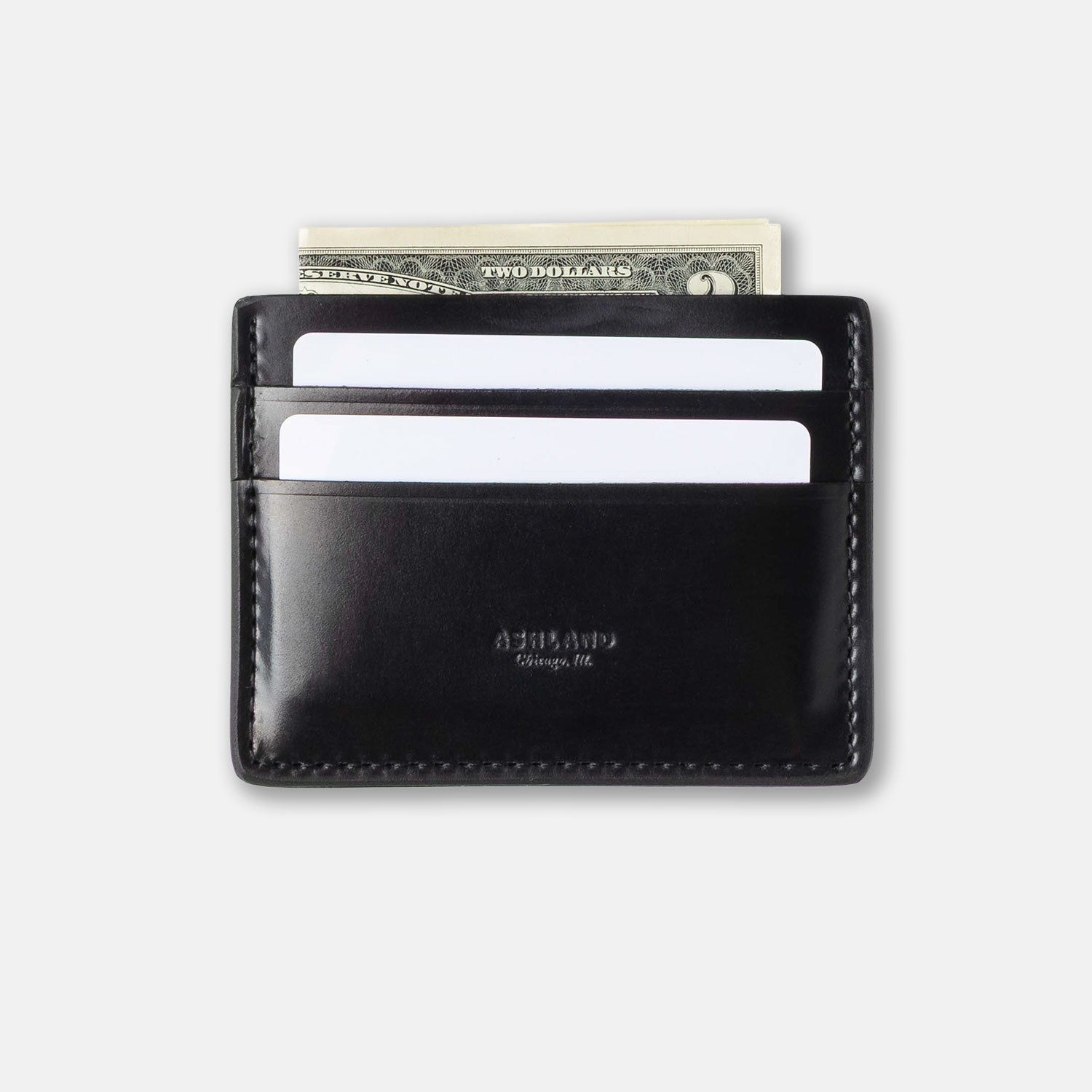 Black leather wallet with money and cards on a light gray background