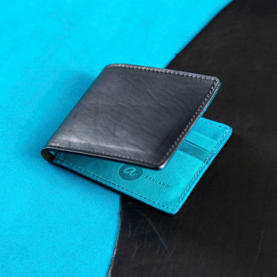 black and blue johnny the fox wallet on a textured surface with a brand logo.