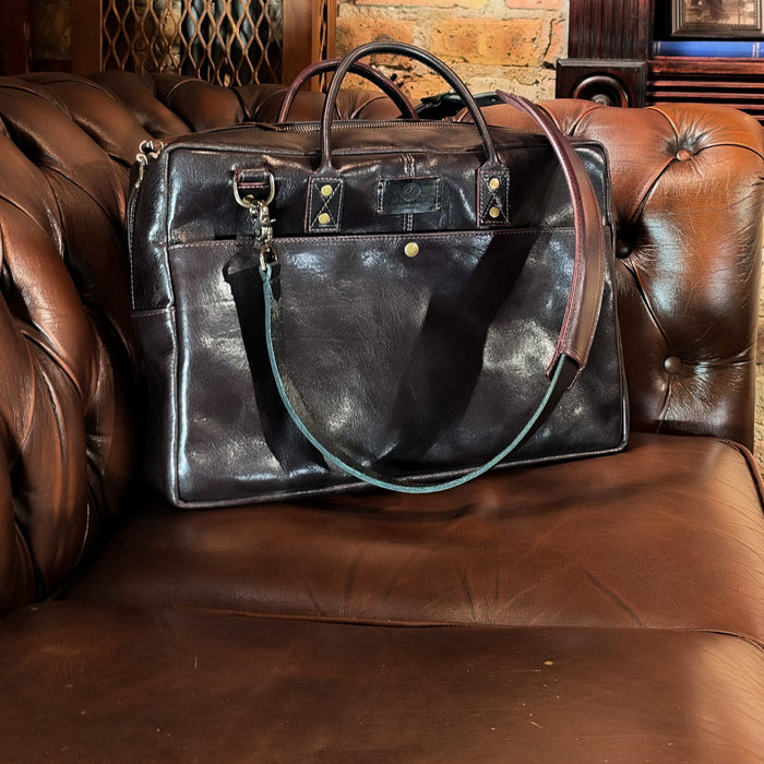 The LaSalle leather briefcase showing its front quick-access pocket with brass snap and Ashland Leather patch