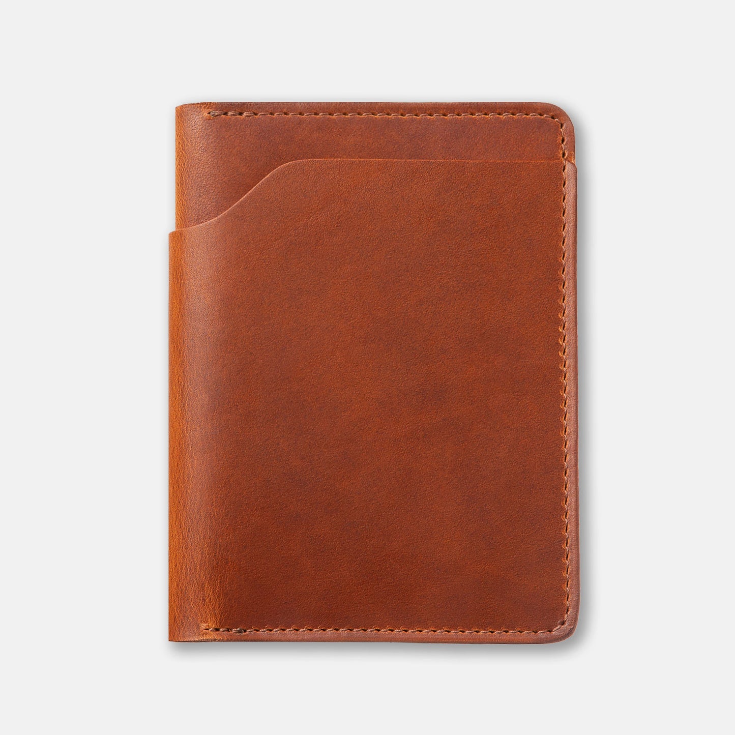 A brown, bi-fold leather wallet with card slots and some cash protruding from the bill slot, placed on a flat surface.