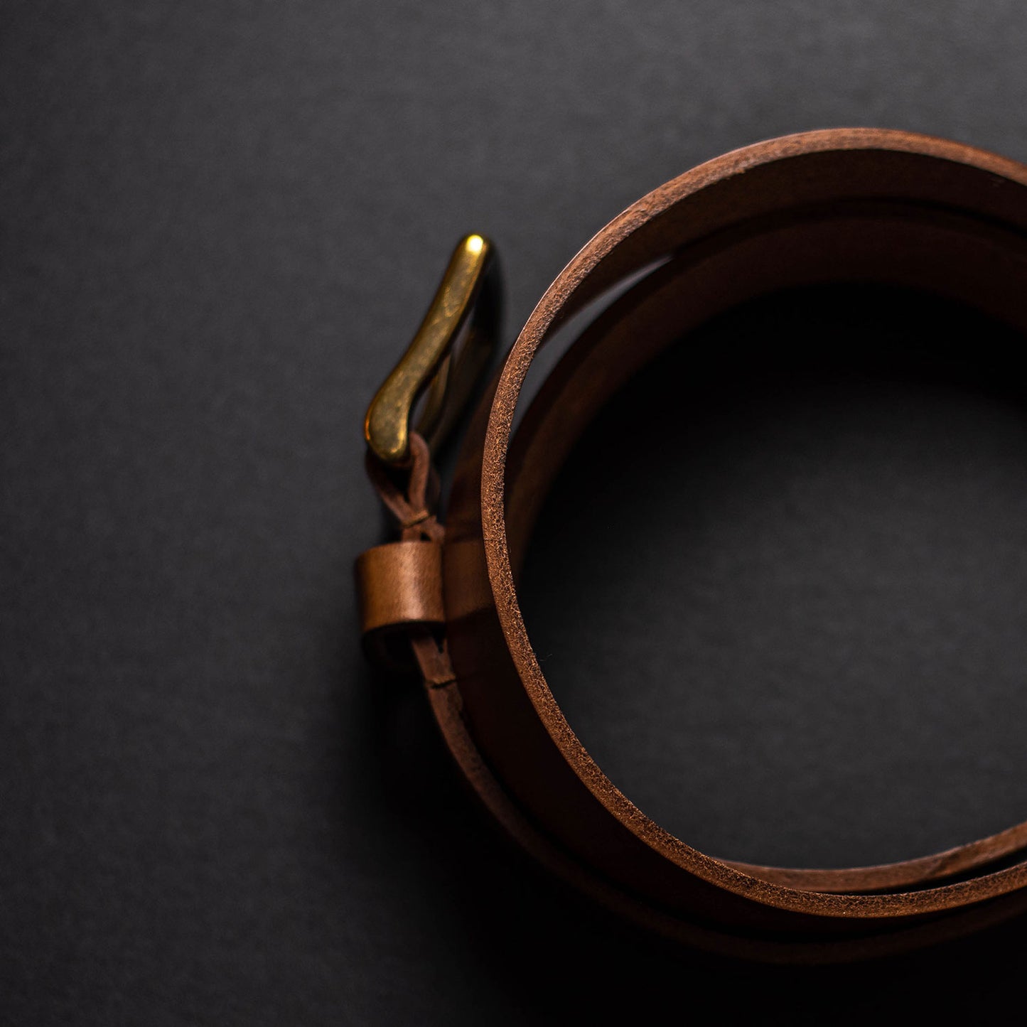 Top view of an Ashland Horween leather chromexcel belt with brass buckle