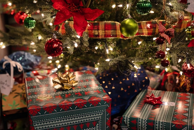 Wrapped holiday gifts beneath a decorated Christmas tree