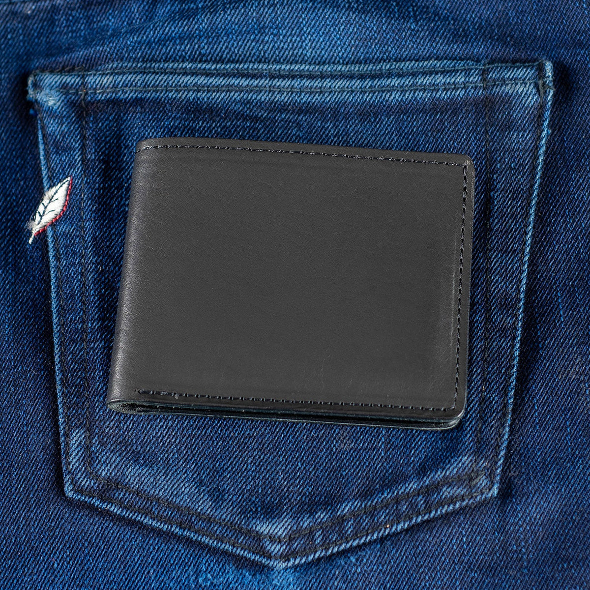 The Daily Carry wallet: closed Johnny the Fox in black Horween® Dublin in the back pocket of jeans