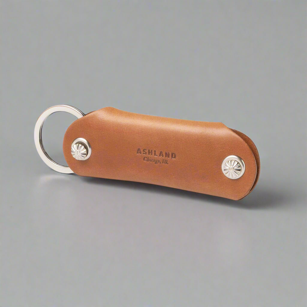 Brown leather keychain with silver accents on a white background