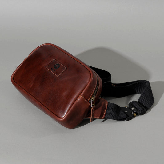 Sling Bag in Horween® Chromexcel® Brown Wooly horsehide, front three-quarter view with black webbing strap