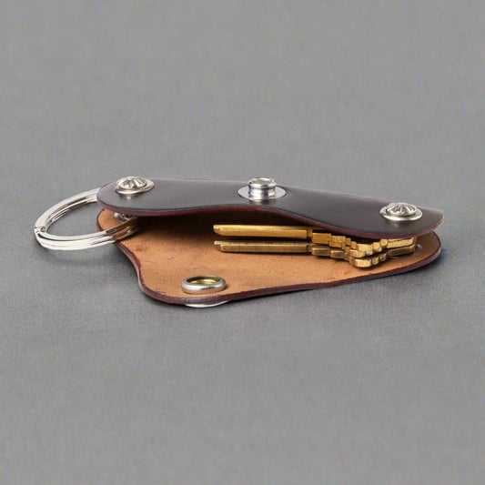 Leather key organizer with keys on a white background