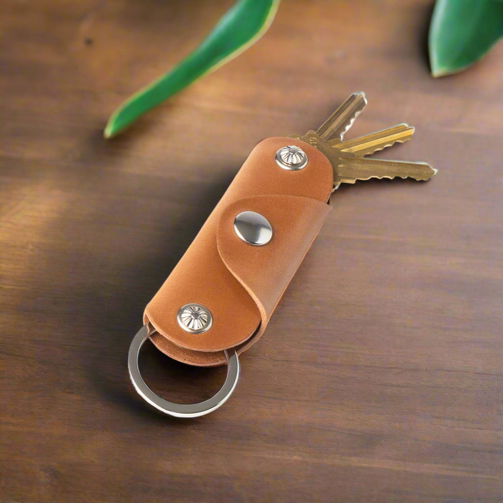 Brown leather key organizer with keys on a white background