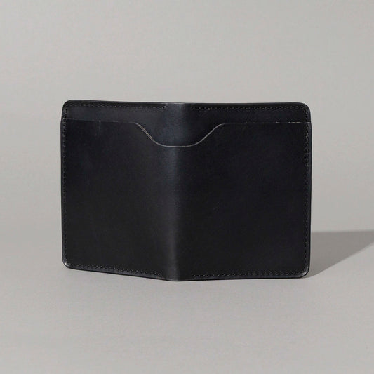 Front of the closed B-Grade Fat Herbie in black Horween® Dublin with a curved thumb notch above the front pocket