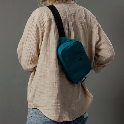 One-off Sling Bag in Horween® Teal Latigo leather, worn on the back, rear three-quarter view