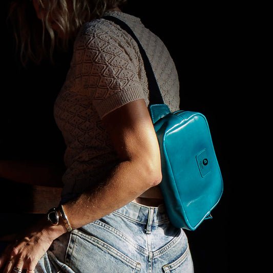 One-off Sling Bag in Horween® Teal Latigo leather, worn crossbody by a woman