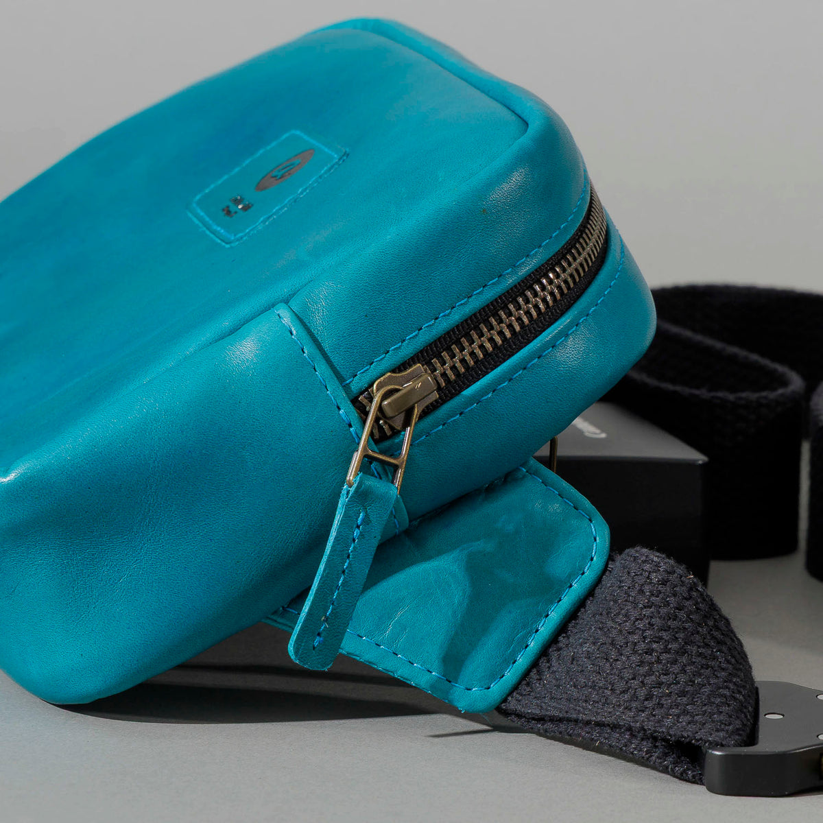 One-off Sling Bag in Horween® Teal Latigo leather, zipper and strap tab close-up