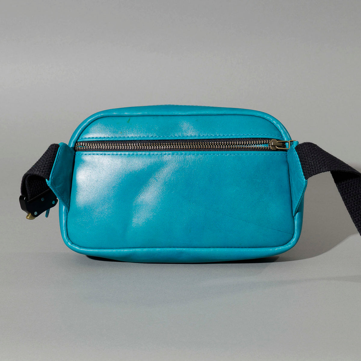 One-off Sling Bag in Horween® Teal Latigo leather, back view showing the exterior pocket