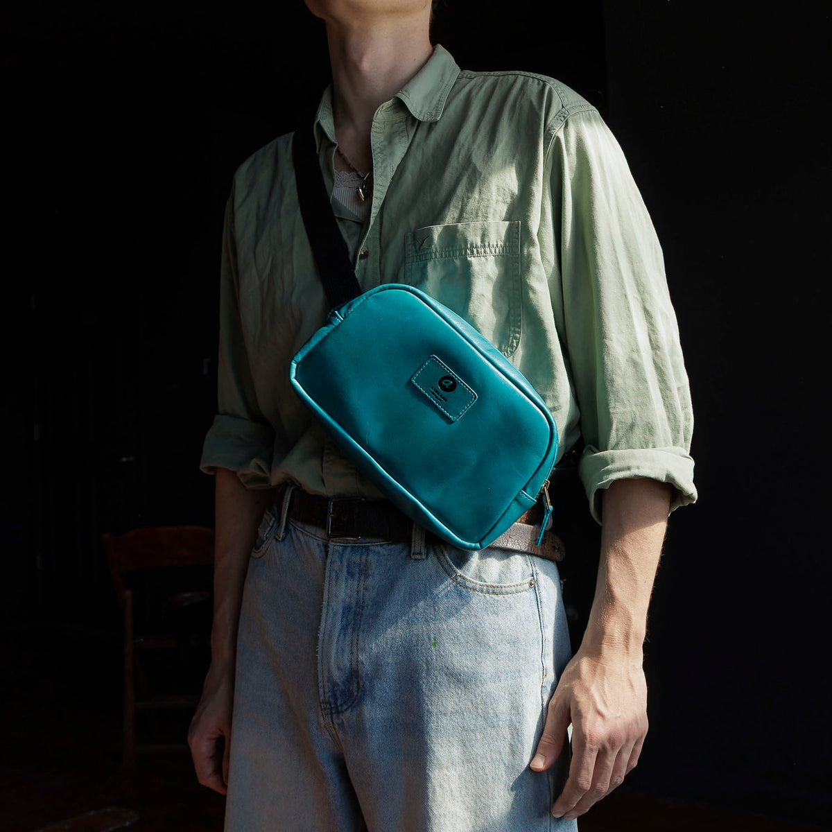 One-off Sling Bag in Horween® Teal Latigo leather, worn crossbody on the chest