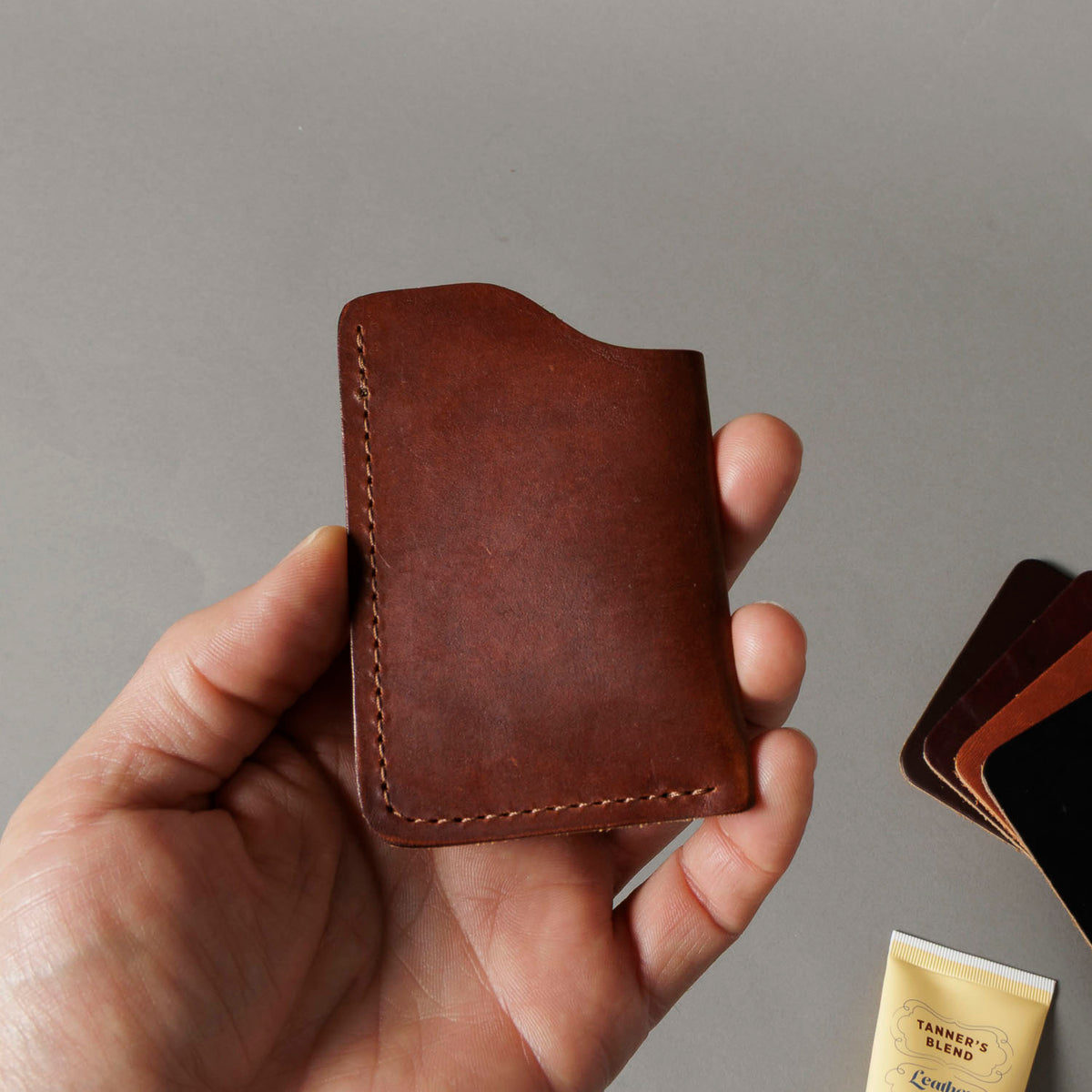 Ashland Leather Mystery Box, brown Horween® leather front pocket card wallet held in hand