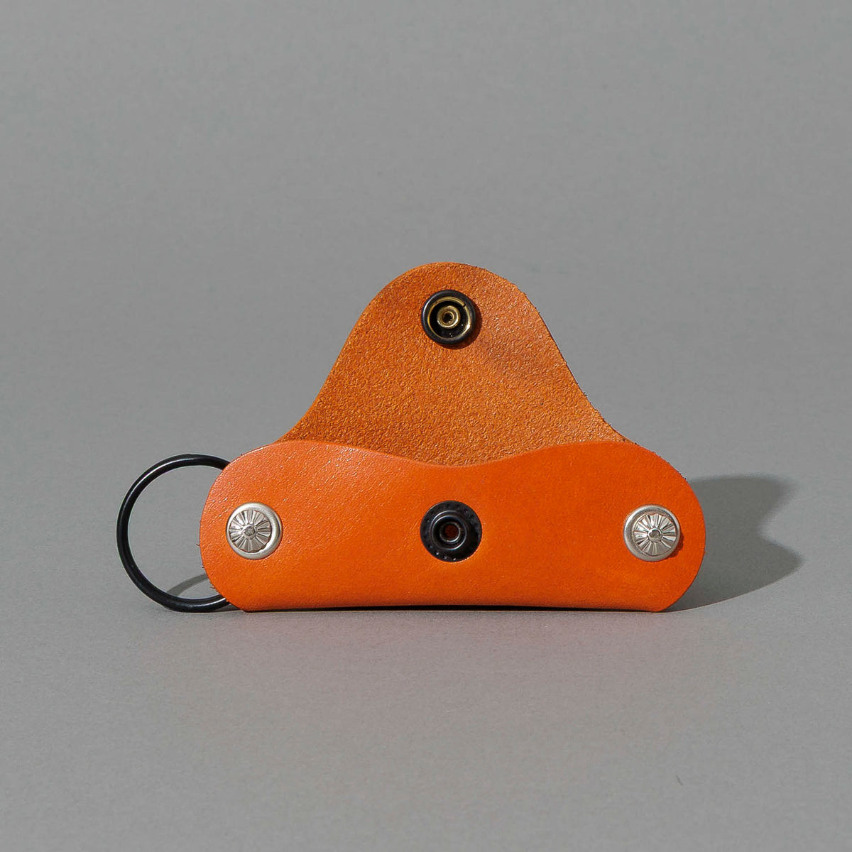 Vault Key Holder in Orange Latigo, opened to show where keys sit, shot 1