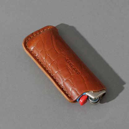 BIC Lighter and Sheath in Gator Amaretto Shell Cordovan, angled view lying flat