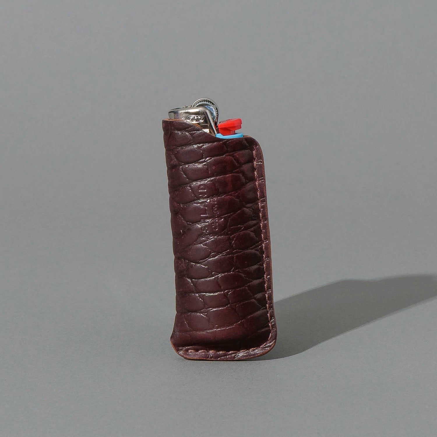 One-Off BIC Lighter and Sheath in Gator Color 8 Shell Cordovan, standing upright, side angle, shot 1