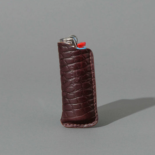 One-Off BIC Lighter and Sheath in Gator Color 8 Shell Cordovan, standing upright, side angle, shot 1