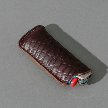 One-Off BIC Lighter and Sheath in Gator Color 8 Shell Cordovan, angled view lying flat