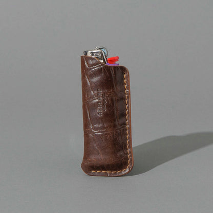 One-Off BIC Lighter and Sheath in Gator Cigar Shell Cordovan, standing upright, side angle, shot 1