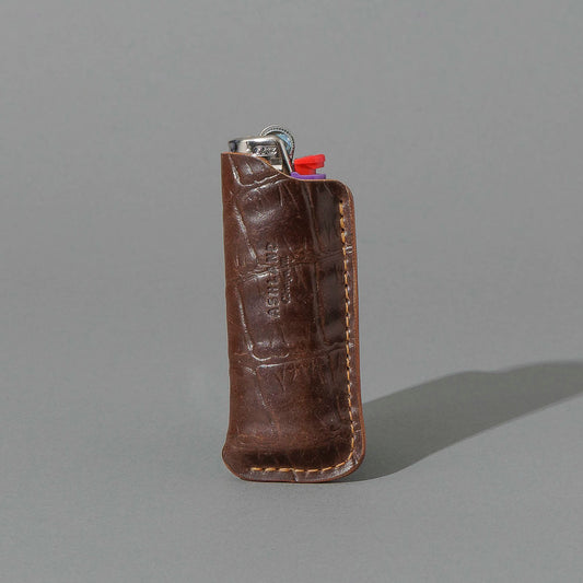 One-Off BIC Lighter and Sheath in Gator Cigar Shell Cordovan, standing upright, side angle, shot 1