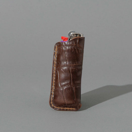 One-Off BIC Lighter and Sheath in Gator Cigar Shell Cordovan, standing upright, side angle, shot 2