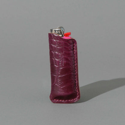 One-Off BIC Lighter and Sheath in Gator Ultraviolet Shell Cordovan, standing upright, side angle, shot 1