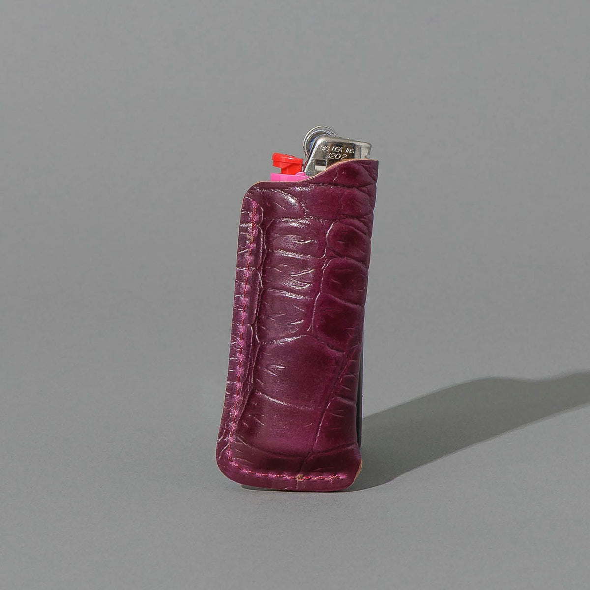 One-Off BIC Lighter and Sheath in Gator Ultraviolet Shell Cordovan, standing upright, side angle, shot 2
