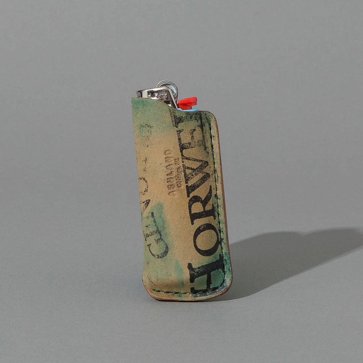 One-Off BIC Lighter and Sheath in Reverse Blue Shell Cordovan, standing upright, side angle, shot 1