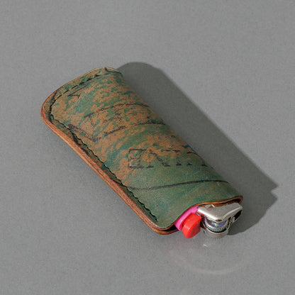 One-Off BIC Lighter and Sheath in Reverse Blue Shell Cordovan, angled view lying flat