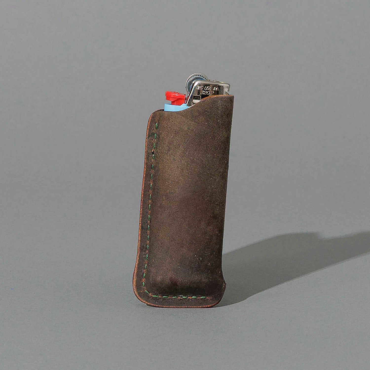 One-Off BIC Lighter and Sheath in Reverse Shell Cordovan, standing upright, side angle, shot 2