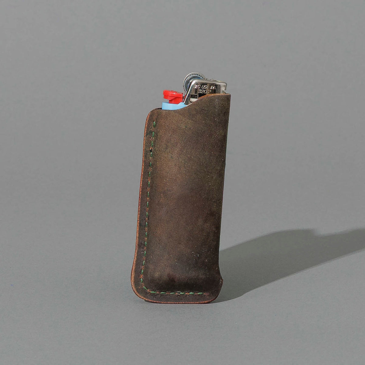 One-Off BIC Lighter and Sheath in Reverse Shell Cordovan, standing upright, side angle, shot 2