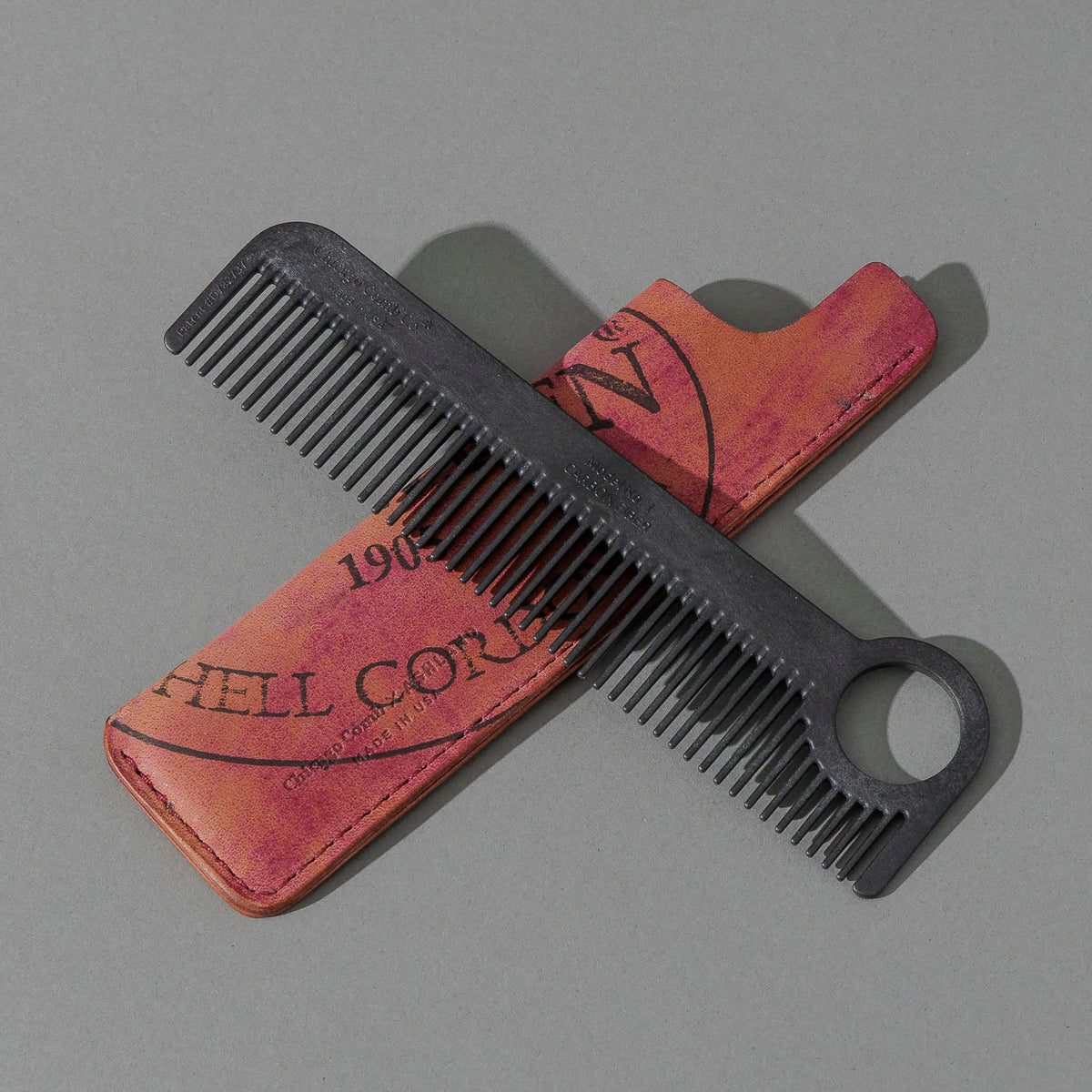 Chicago Comb and Leather Sheath in Reverse Ultraviolet Shell Cordovan, with a black Chicago Comb crossed over the sheath