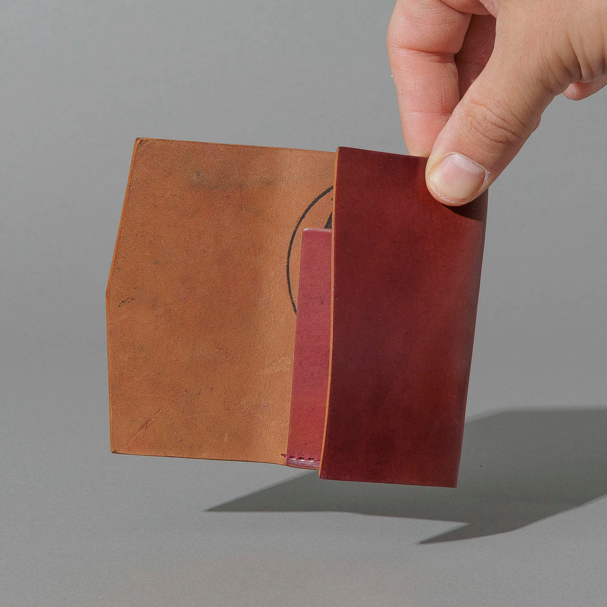 One-Off Jr. Fold in Marbled Ultraviolet Shell Cordovan, held open in hand